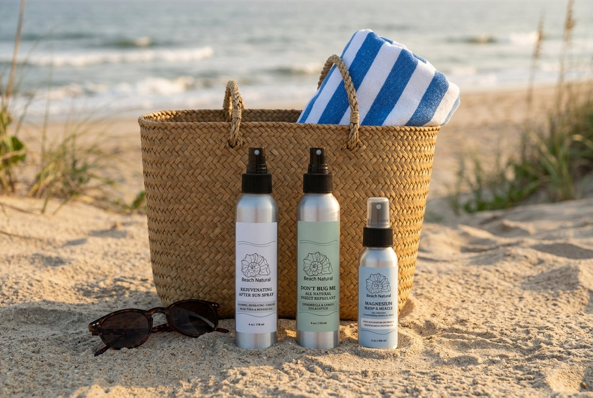 Beach Natural After Sun Spray, Don't Bug Me insect repellent, and Magnesium Spray in a woven beach tote on an Outer Banks beach